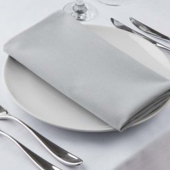 A white table set with silverware and a grey napkin